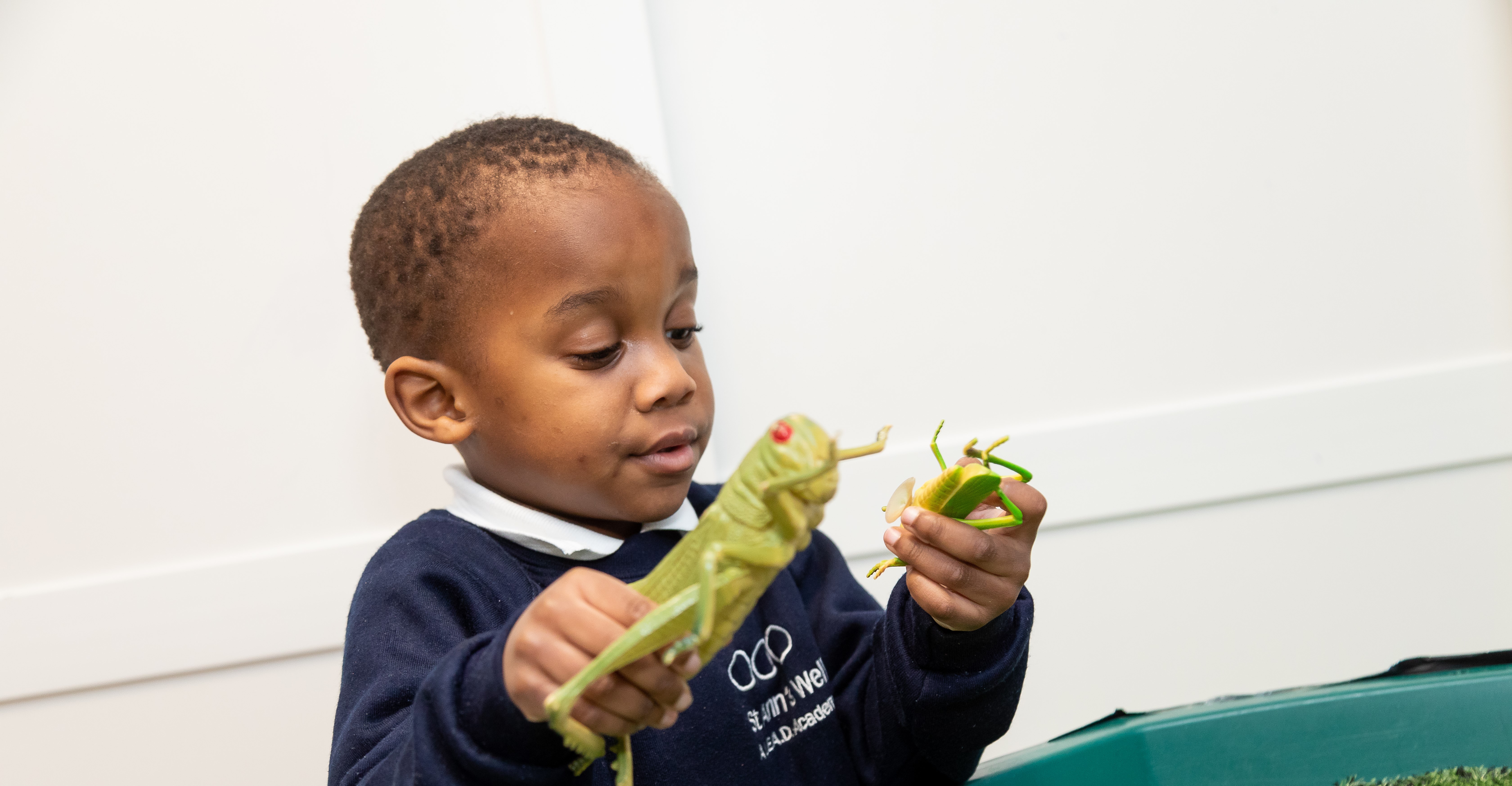 St Anns Well boy playing with insect toys KAM_3010